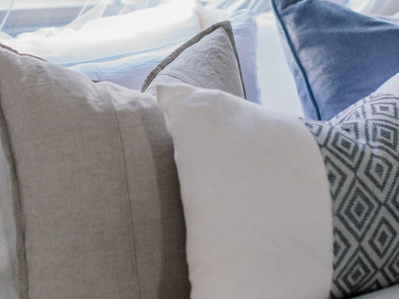 Sofa styled with layered throw pillows in mixed textures
